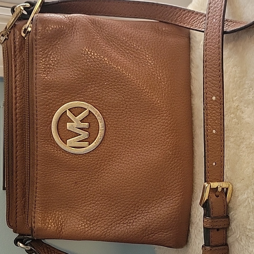 Small Michael Kors crossbody bag brown leather with brass hardware.